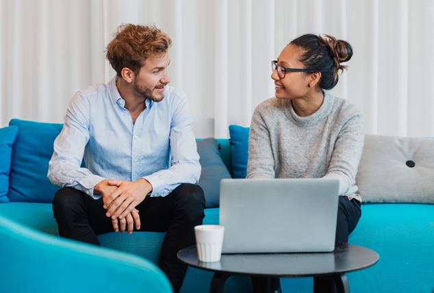 Two women have a discussion in an office